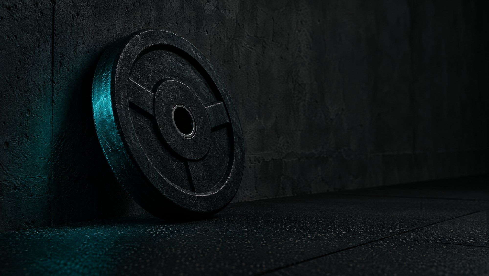 A black iron weight plate leaning against a dark concrete wall on a rubber gym floor, its edge lit in deep teal light.